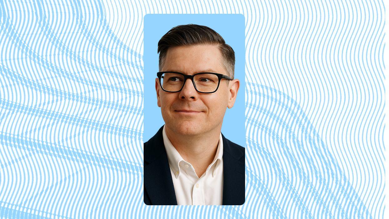 Man wearing glasses with blue background